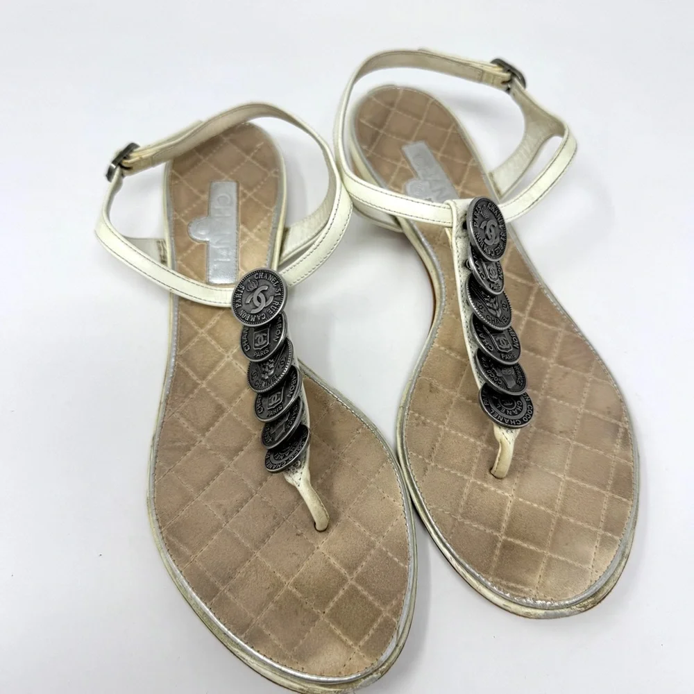 CHANEL White Leather Thong Sandals with Stacked Silver Coin Medallions